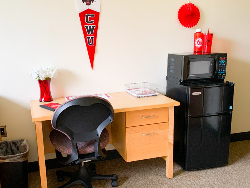 Desk and a microwave and fridge combo unit