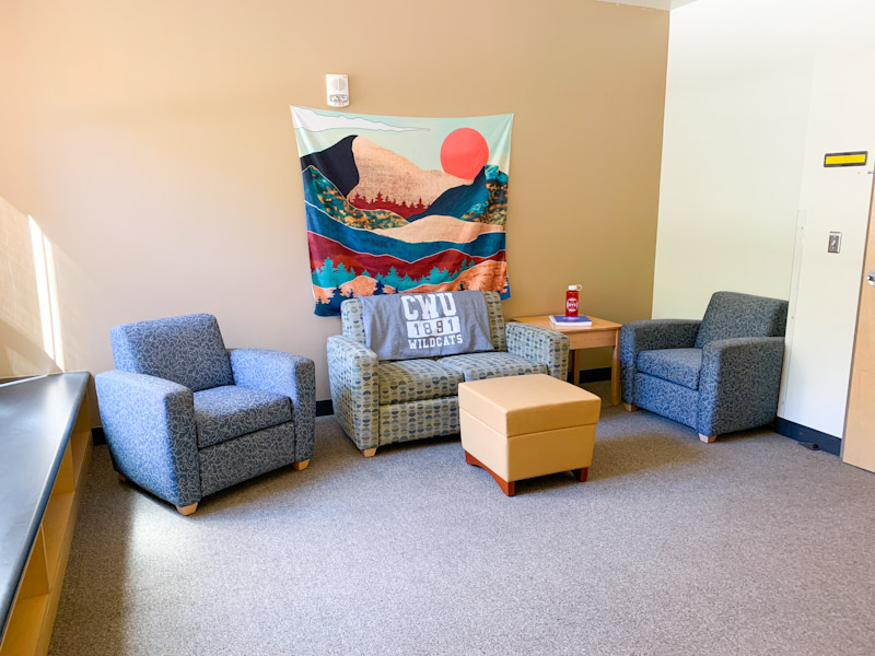 Living room area with couch and two chairs