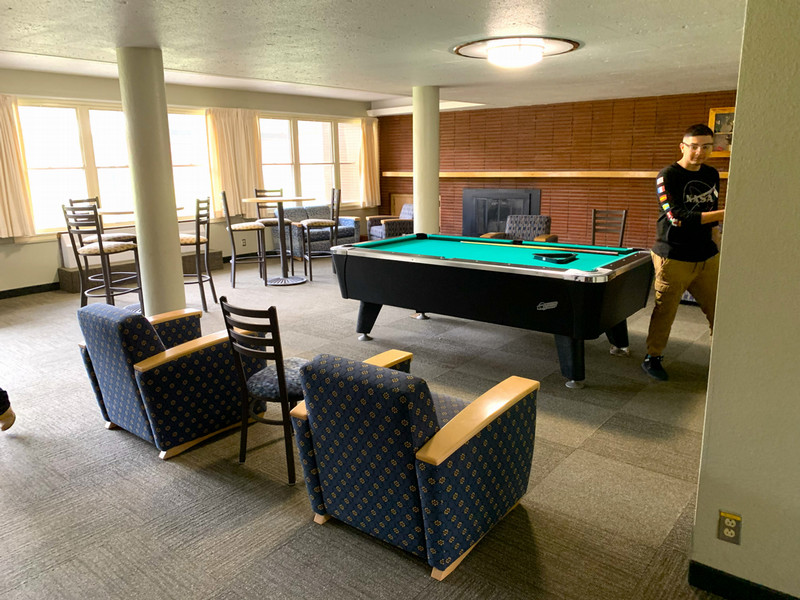 Lounge with couches, chairs and a pool table