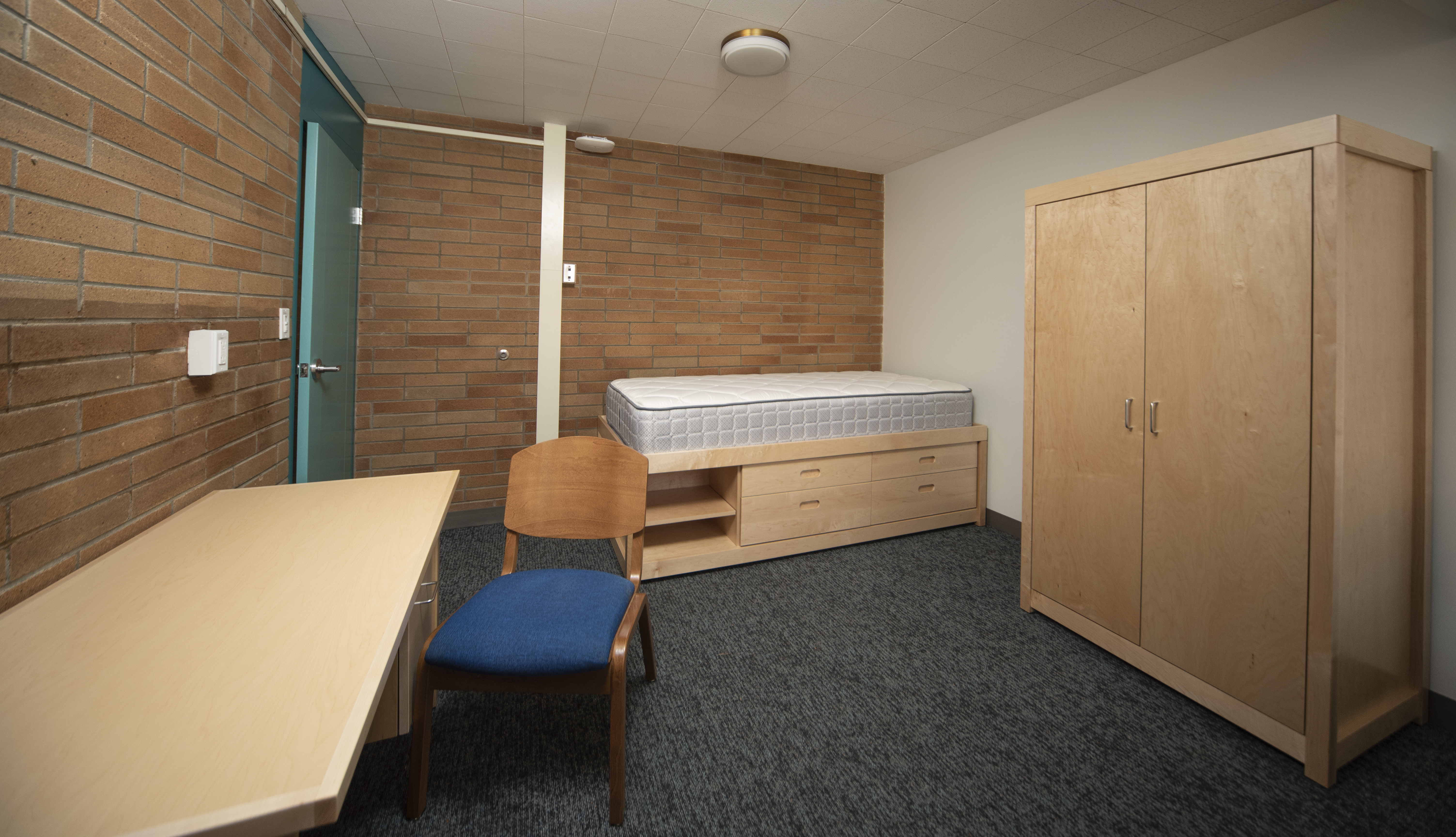 Single room with a twin XL bed, desk, and closet