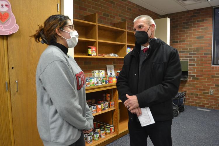 A student and administrator conversing at the CWU Wildcat Pantry.